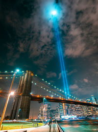 Low angle view of illuminated bridge against sky at night