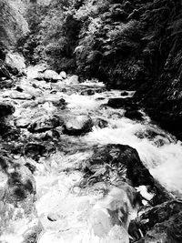 View of river flowing through rocks