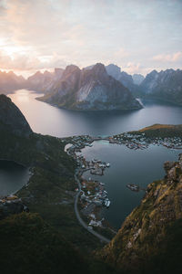 Scenic view of lake and mountains against cloudy sky