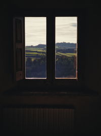 Trees seen through window of house