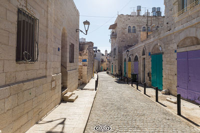 Empty alley amidst buildings in city