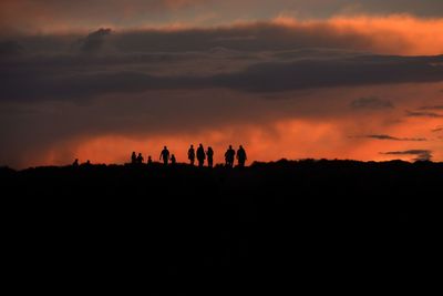 Silhouette landscape against dramatic sky