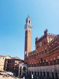 Low angle view of historical building against clear blue sky