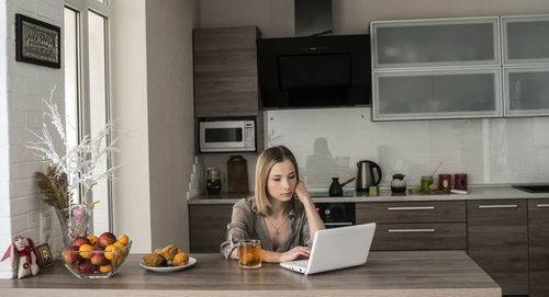 Woman working on laptop at home