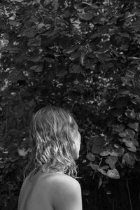 Rear view of man standing by plants