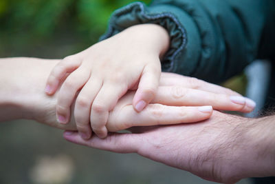 Cropped image of people stacking hands