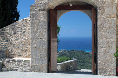 Built structure by sea against clear sky