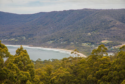 Scenic view of sea and mountains against sky