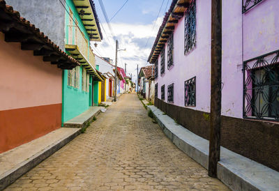 Empty alley amidst buildings in city