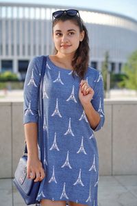 Beautiful woman wearing dress with eiffel tower pattern looking away