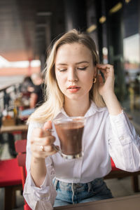 Young woman drinking glass