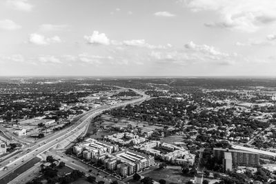 Aerial view of cityscape against sky on sunny day