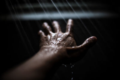 Close-up of hand taking shower