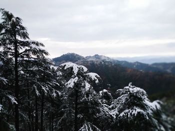 Scenic view of snow covered mountains against sky