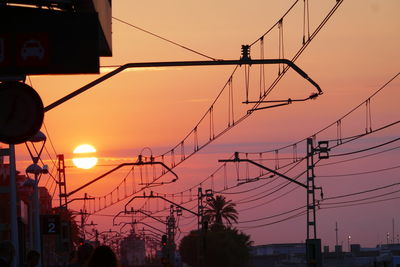 Silhouette of overhead catenary at sunset near  barcelona.