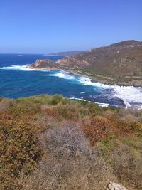 Scenic view of beach and sea against clear sky