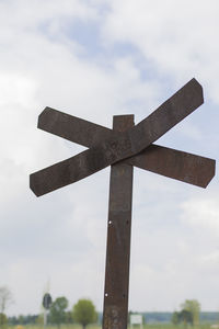 Low angle view of cross sign against sky