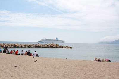 People on beach against sky