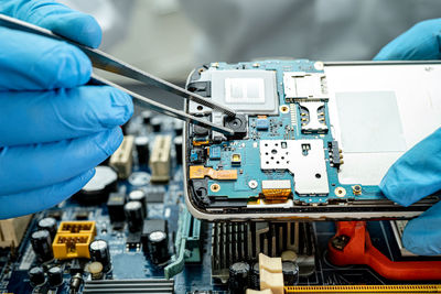 Midsection of man repairing circuit board