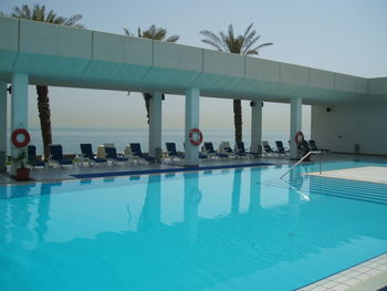 People in swimming pool against sky