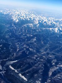 Aerial view of snowcapped mountain against sky