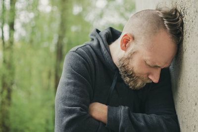 Man leaning on wall