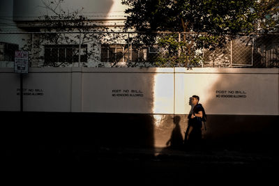 Full length of woman standing by railing