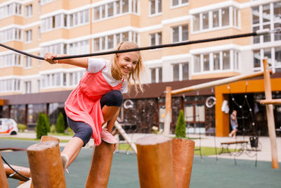 Low angle view of girl against building