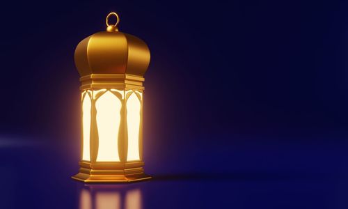 Low angle view of lamp against blue background