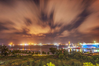 Illuminated cityscape against sky at night