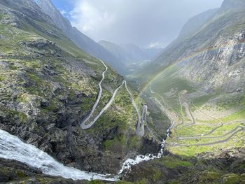 Scenic view of valley and mountains against sky