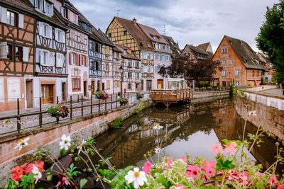 Canal amidst buildings against sky