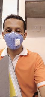 Portrait of man covering face