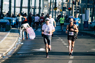 People walking on road in city