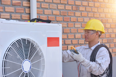 Portrait of young man working in factory