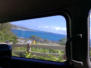 Scenic view of landscape seen through window