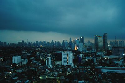 Illuminated cityscape against sky