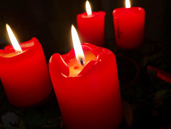 Close-up of lit candles in the dark