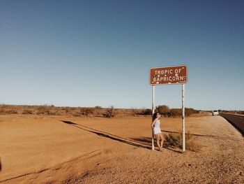Full length of a woman standing on desert