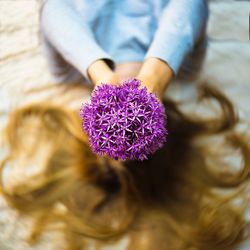 Close-up of woman on purple flowering plant