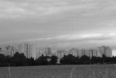 View of buildings against cloudy sky