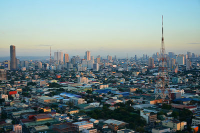 High angle view of modern buildings in city against sky during sunset