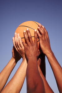 Low angle view of woman playing basketball