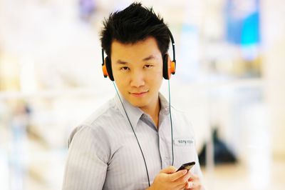 Portrait of mid adult man using smart phone outdoors