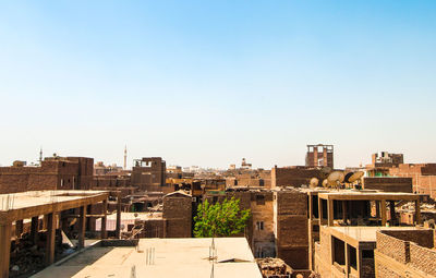 High angle view of buildings against clear blue sky