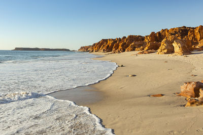 Scenic view of beach against clear sky