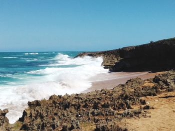 Scenic view of sea against clear blue sky