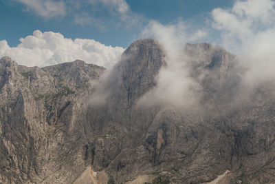 Panoramic view of land and mountains against sky