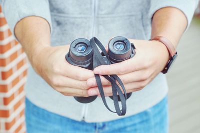 Close-up of man holding binoculars