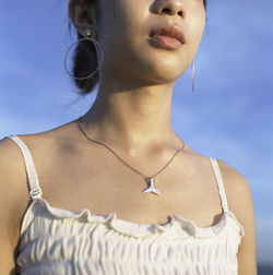 Midsection of woman against sky
